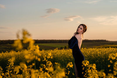 Full length of woman standing on field