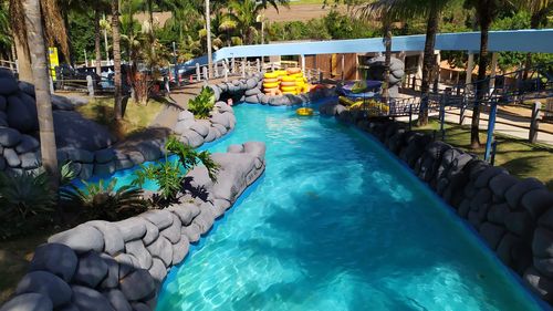 People relaxing by swimming pool