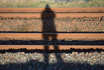 Man standing on railroad track