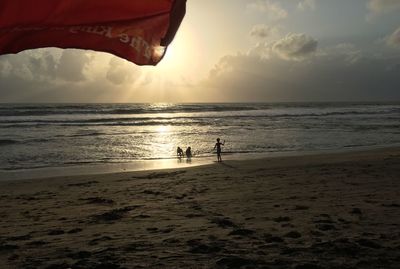 Scenic view of beach against sky during sunset