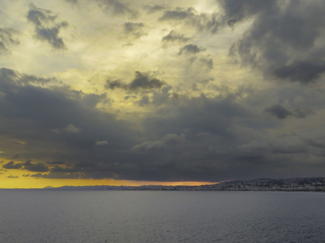 sky, cloud, water, beauty in nature, scenics - nature, horizon, sea, dramatic sky, nature, sunset, environment, tranquility, dawn, tranquil scene, ocean, storm, no people, sunlight, coast, shore, evening, cloudscape, seascape, landscape, outdoors, horizon over water, reflection, land, idyllic, beach, moody sky, awe, overcast, travel destinations, storm cloud, atmospheric mood