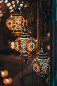 Illuminated lanterns hanging in market at night