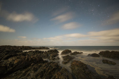 Scenic view of sea against clear sky at night