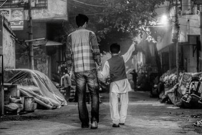 Rear view of men on street