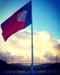 Low angle view of flag against sky during sunset