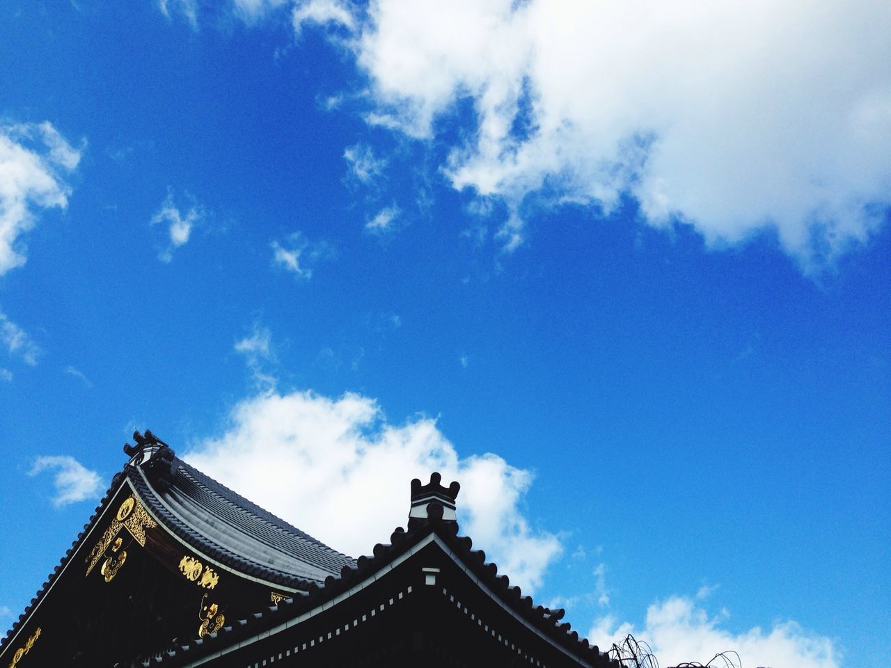 low angle view, architecture, built structure, sky, building exterior, cloud - sky, blue, high section, cloud, cloudy, day, outdoors, no people, place of worship, religion, roof, famous place, architectural feature, history, spirituality