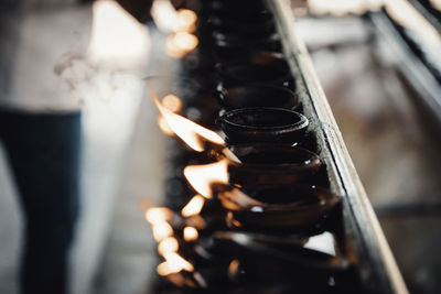 Close-up of diyas in temple