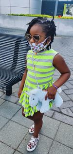 Cute girl wearing sunglasses standing outdoors