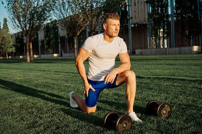 Portrait of young man exercising in park