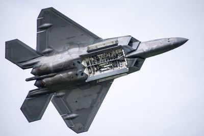 Low angle view of airplane flying against clear sky