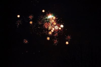 Low angle view of firework display at night