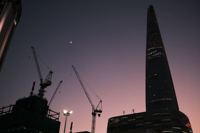 Low angle view of illuminated buildings against clear sky