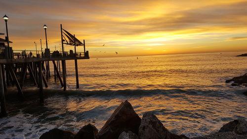 Scenic view of sea against sky at sunset