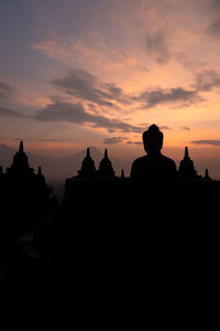 Silhouette temple against sky during sunset