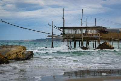 Built structure on beach against sky