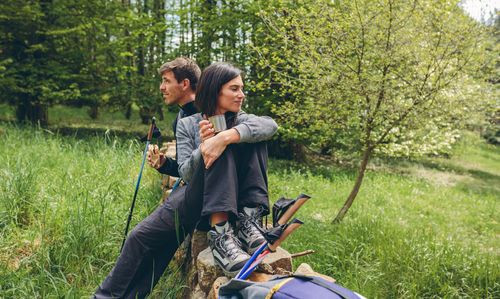 Full length of young couple on field