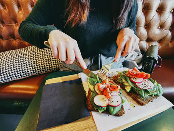 Midsection of woman preparing food at restaurant