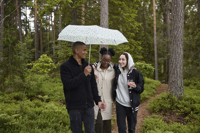 Friends walking through forest