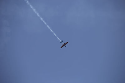 Low angle view of airplane flying in sky