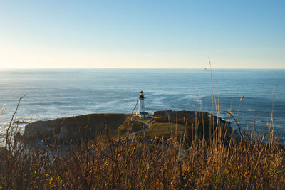 Scenic view of yaquina head lighthouse at sunset, newport, oregon