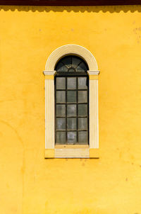 Window on yellow wall
