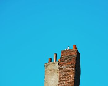 Low angle view of building against clear blue sky