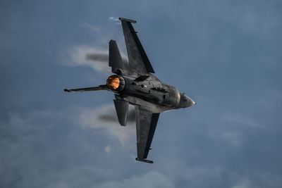 Low angle view of airplane flying against sky