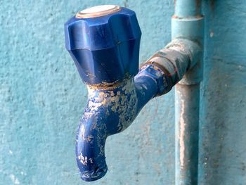 Close-up of fire hydrant against blue wall