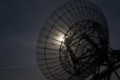 Low angle view of satellite dish against sky during sunset