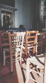 Empty chairs and tables in cafe against building