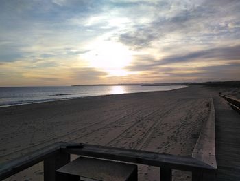 Scenic view of beach against sky during sunset