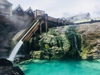 Scenic view of waterfall against sky