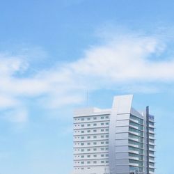 Low angle view of building against cloudy sky