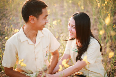 Side view of smiling couple kissing girlfriend