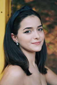 Close-up portrait of a smiling young woman