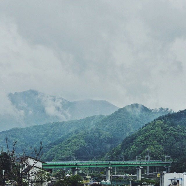mountain, mountain range, tree, scenics, sky, tranquil scene, tranquility, beauty in nature, landscape, cloud - sky, nature, non-urban scene, cloudy, idyllic, cloud, day, railing, outdoors, remote, valley