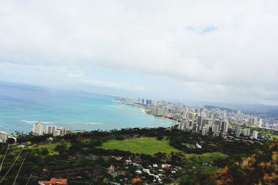 High angle view of buildings and sea against sky