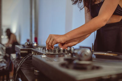 Fashionable young woman playing music at home