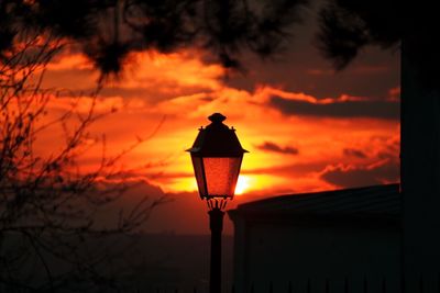 Close-up of street light against orange sky during sunset