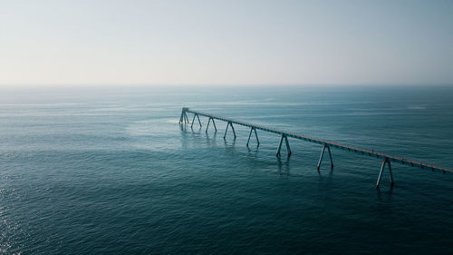 Pier over sea against clear sky