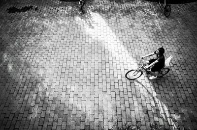 High angle view of woman riding bicycle on street