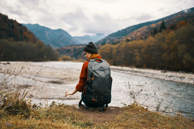 Rear view of man standing on land against sky