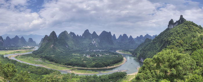 Panoramic view of landscape against cloudy sky