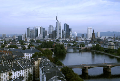 View of cityscape against cloudy sky