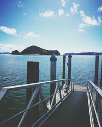 Railing by sea against sky