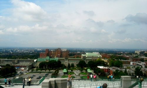 Cityscape against cloudy sky