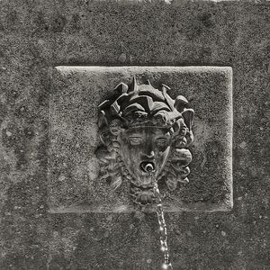 Close-up of old sculpture against wall