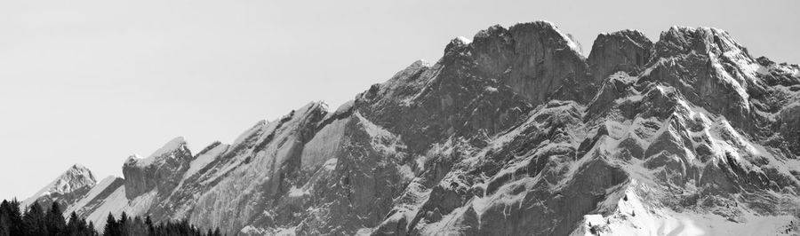 Panoramic view of snowcapped mountains against clear sky