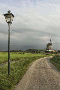 Street light on field against sky