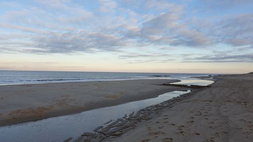 Scenic view of beach against sky during sunset